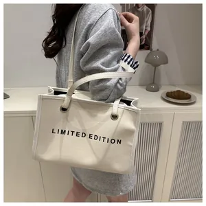 Detailed view of a beige canvas tote bag with Limited Edition text shown in a lifestyle setting
