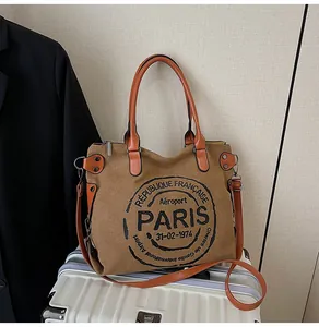 Detailed macro view of the vintage canvas tote bag showing the retro Paris stamp print