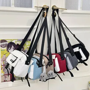 Collection of multi-colored nylon crossbody bags with octopus plush charms hanging on door