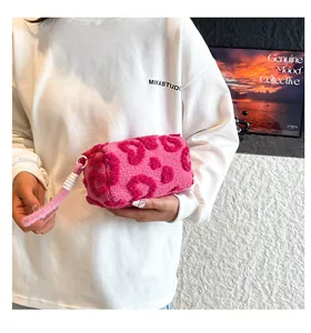 Macro detail of plush heart pattern handbag with cylinder shape and soft faux fur texture