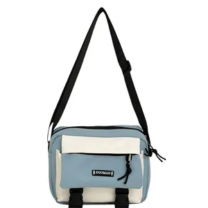 Blue and white minimalist messenger bag in durable nylon with adjustable shoulder strap