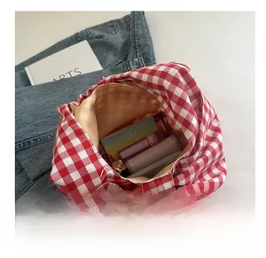 Top view of spacious red checkered canvas tote bag interior with everyday essentials