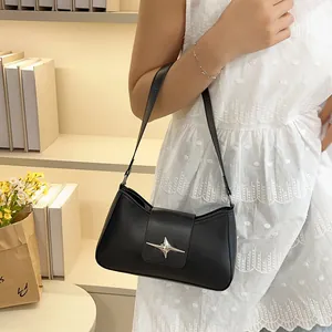 Gros plan d'un sac sous les bras en cuir noir avec une boucle en métal en forme d'étoile