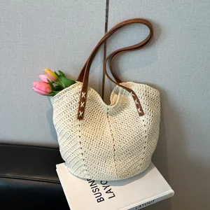 Handmade woven tote bag in creamy white with brown leather straps for beach vacation