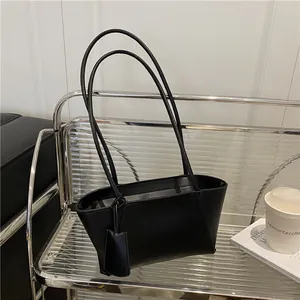 Classic large black tote bag in matte leather on display shelf for a vintage look