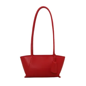Minimalist red faux leather shoulder bag with sleek trapezoidal shape and double straps