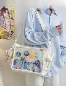 Detail of white canvas Ita bag featuring transparent PVC window for anime badge display