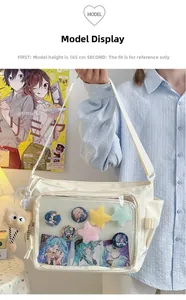 Detail of white nylon tote bag featuring a clear window for anime badges and plush charms