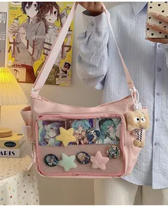 Pink canvas ita bag with a clear PVC window and a brown plush doll charm for students