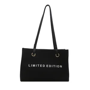 Black canvas tote bag with Limited Edition print and golden metal rings for women