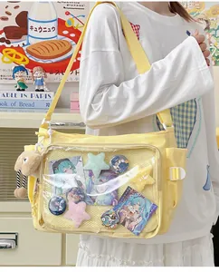 Detailed view of yellow canvas ita bag with a clear PVC window for anime badge display
