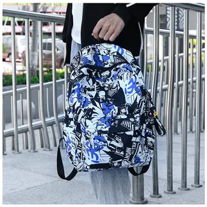 Detail of blue graffiti backpack with 'KILL THE NIGHT' print and side hanging accessory