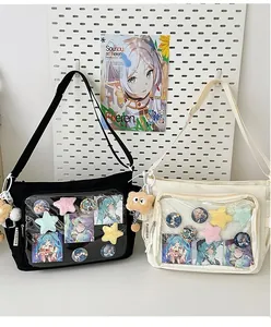 Detail view of ita bag transparent window displaying anime badges and star plush decorations