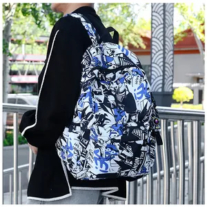 Outdoor view of a trendy graffiti backpack with astronaut charm and side pocket details