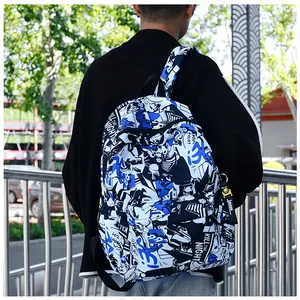 Large student backpack with blue comic graffiti print and street style mask charm