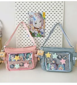 Detail of ITA bag showing transparent PVC window for anime badges and plush bear charm