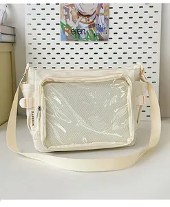Detail of cream canvas ita bag featuring a transparent front window for badge display