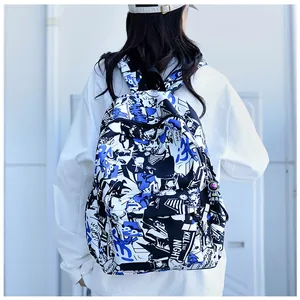 Detail of a graffiti print backpack with astronaut charm and large main compartment