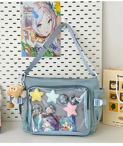 Close-up of light blue ita bag with transparent window for anime badges and plush cat charm