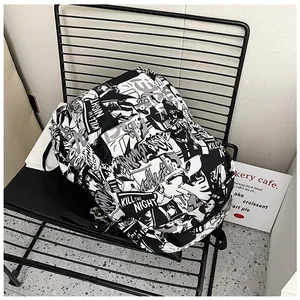 Detail of a large capacity backpack featuring black and white comic print and top handle