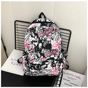Detail view of stylish graffiti pattern backpack with side pocket and hanging decoration