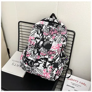 Detail of cartoon graffiti backpack featuring astronaut charm and waterproof fabric