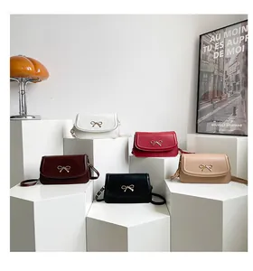Collection of five elegant minimalist crossbody bags with metallic butterfly clasps