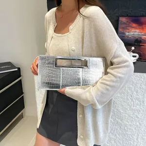 Silver crocodile embossed clutch bag with sleek rectangular metal handle and modern finish