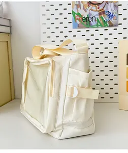 Detail view of cream canvas tote with transparent PVC pocket for displaying decorations