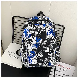Detail of blue graffiti backpack with multi-layer zipper compartments on a grid chair