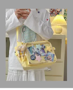 Yellow canvas messenger bag with a large transparent PVC window for anime badges and charms
