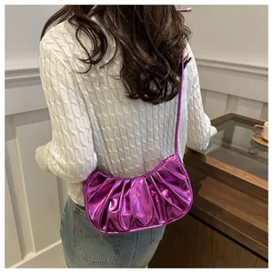 Close-up of bright purple metallic pleated hobo bag showing texture and crescent shape