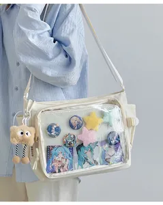 Detail of cream canvas ita bag with a large transparent PVC window for badge display