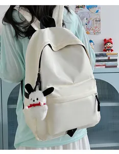 Minimalist beige nylon backpack with cute plush charm showing spacious back view detail