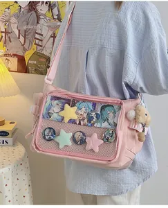 Detail of light pink ita bag featuring a clear PVC window for anime badge display
