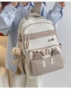 Detail of Korean-style large backpack featuring two-tone design and plush pendant