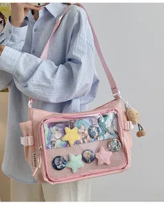 Pink ita bag with large clear PVC window and plush bear pendant detail