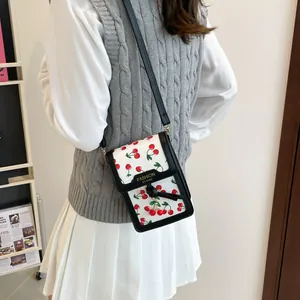 French retro white crossbody mini bag with red cherry print and black edge detailing