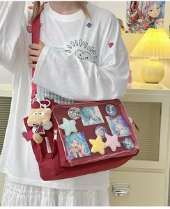 Detail of red canvas ita bag with transparent PVC window for anime badges and charms