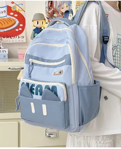 Detail of light blue nylon backpack with cat ears and 3D Dream lettering for students