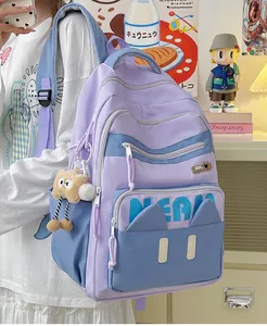 Detail of light purple school backpack with blue contrast and plush animal charm