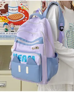 Detail view of large capacity lavender and blue student backpack with MEAM cat ear decor