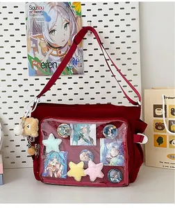Macro view of red canvas ita-bag with large transparent display window and pins