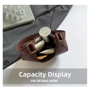 Top view showing the internal capacity of the brown lychee grain leather crescent bag