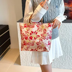Pink jacquard tote bag with floral patterns and natural bamboo handles for women