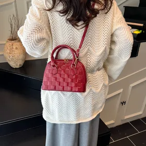 Glossy red crocodile shell bag for women with checkered texture and crossbody strap