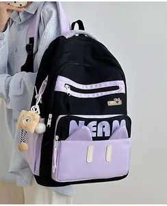 Detail shot of the large capacity nylon backpack in black and purple with a plush bear charm