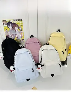 Detailed collection of minimalist nylon backpacks in five colors with plush pendants