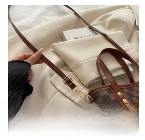 Close-up of the vintage checkerboard tote bag with gold-tone hardware and snap hook