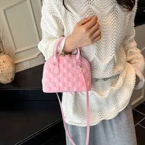 Pink jelly shell bag with waffle texture and golden hardware shown on a model